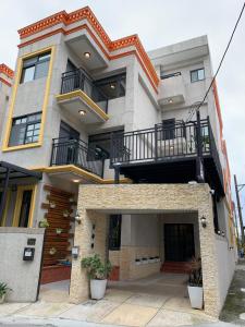 a large building with a balcony on top of it at 910 Hostel 城南館-自助入住 in Yuli