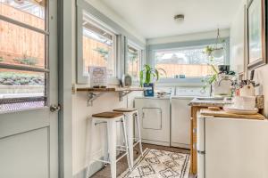 a kitchen with a washer and dryer next to a window at Cascade Cabana & Home in Hood River