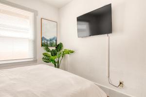 a bedroom with a flat screen tv on a wall at Cascade Cabana & Home in Hood River