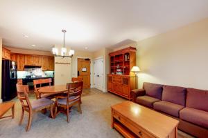 a living room with a couch and a table at Founders Lodge 209 in Stratton