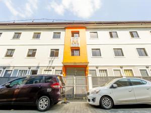 two cars parked in front of a building at Super OYO 841 Metro Deluxe Residences in Manila