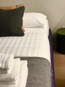 Una cama con sábanas blancas y almohadas. en Dimore al Te, en Mantua