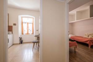 a living room with a table and a bedroom at Apartment Ferienwohnung in Pula