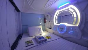 a small room with a bed in an airplane at TABHotel Capsule Bandung in Bandung