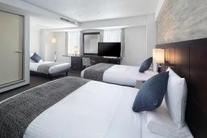 Postel nebo postele na pokoji v ubytování ART HOTEL Nippori Lungwood