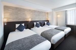 Postel nebo postele na pokoji v ubytování ART HOTEL Nippori Lungwood