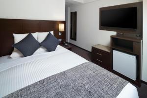 Postel nebo postele na pokoji v ubytování ART HOTEL Nippori Lungwood