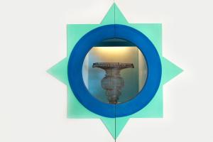 a mirror with a reflection of a tower in it at Villa Lia in Massa Lubrense +26 photos