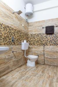 a bathroom with a toilet and a sink at Exotic Stays I 2Bhk Kasauli Home l Mountains & Toy Train View in Kasauli +59 photos