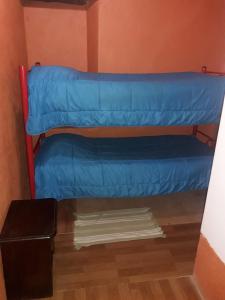 a room with two bunk beds in a room at La Casa Blanca in San Pedro de Atacama