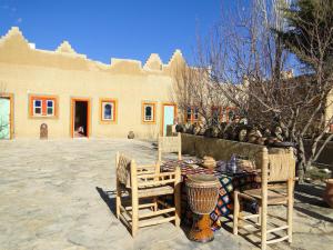 a table and chairs in front of a building at Auberge Ibrahim in Agoudal