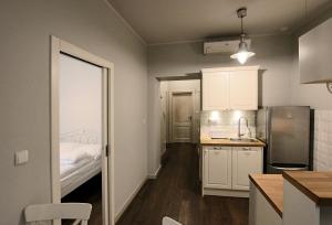a small kitchen with a sink and a bed at Old Town Apartment in Krakow