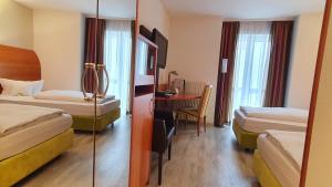 Postel nebo postele na pokoji v ubytování Astralis Hotel Domizil