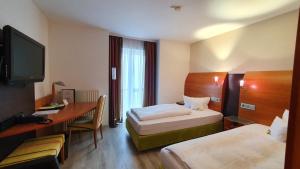 TV a/nebo společenská místnost v ubytování Astralis Hotel Domizil