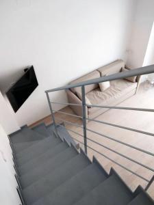 a bedroom with a bunk bed and a couch at Dimora Cappellini in Brindisi