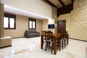 a living room with a table and chairs and a couch at La Piana Hotel in Tito