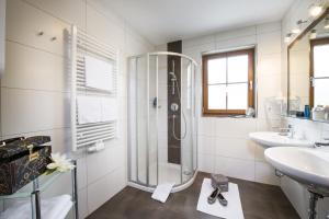 a bathroom with a shower and a sink at Salzburgerhof Flachau in Flachau +45 photos
