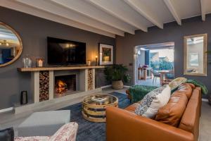a living room with a couch and a fireplace at House w Pool, Fireplace, Braai in Cape Town