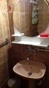 een badkamer met een wastafel en een spiegel bij Vikend Kuca Milica in Kopaonik