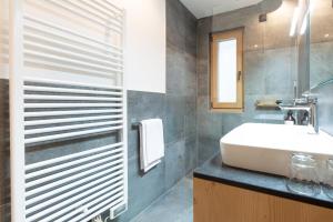 a bathroom with a sink and a mirror at CHALET NORA in San Vigilio Di Marebbe