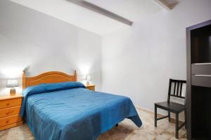 a bedroom with a blue bed and a chair at Casa Marrero Arriba in La Guancha