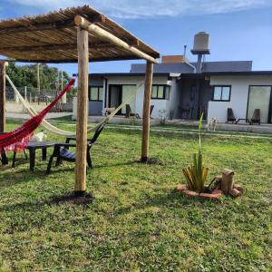 a hammock in a yard with a house at LP Loft Acantilados in Mar del Plata +7 photos