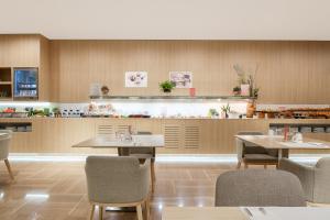 a restaurant with tables and chairs and a counter at Barceló Valencia in Valencia +49 photos