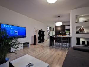 a living room with a large tv on a wall at Sweet Lime Apartments Kaszubska 57m2 in Wrocław