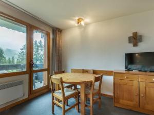 a dining room with a table and a television at Appartement Valmorel, 2 pièces, 4 personnes - FR-1-356-248 in Valmorel