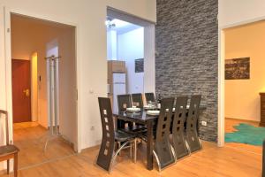 a dining room table and chairs in a room at Central Capital Apartments in Budapest
