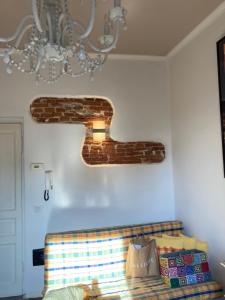 a room with a couch and a chandelier at Casa vacanza sole lago… in Intra