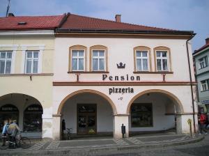 a building with a sign that reads passion pizzeria at Penzion u České Koruny in Jičín