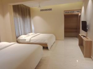 Postel nebo postele na pokoji v ubytování Hotel VPS Grand