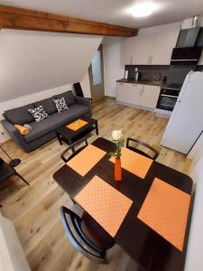 a living room with a table and a couch at Apartmány Rudník Bolkov in Rudník