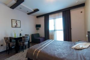 a bedroom with a bed and a table and a chair at Divčibarski Vajati in Divčibare