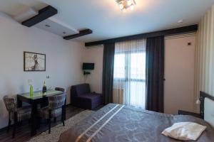 a bedroom with a bed and a table and a chair at Divčibarski Vajati in Divčibare