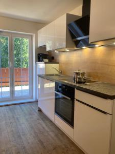 a kitchen with a sink and a stove top oven at Haus Angermann in Mallnitz