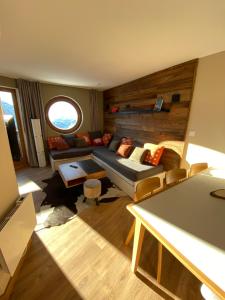 a living room with a couch and a window at Avoriaz le M1212 in Avoriaz