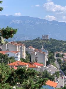 a view of a city with a castle on a hill at Apartment Ivanka in Senj