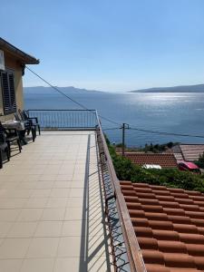 a balcony of a house with a view of the ocean at Apartment Ivanka in Senj