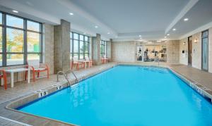 a large swimming pool in a hotel room at Holiday Inn & Suites Oakville at Bronte by IHG in Oakville