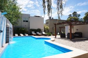 a swimming pool in the backyard of a house at Laguna Park Duplex & Suites in Chascomús