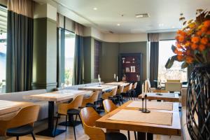 a row of tables and chairs in a restaurant at Imperio Hotel Cernavoda in Cernavodă