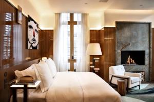 a bedroom with a king sized bed and a fireplace at Rosewood São Paulo in Sao Paulo