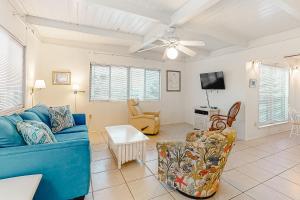 a living room with a blue couch and a tv at Campbellot by Meyer Vacation Rentals in Fort Morgan