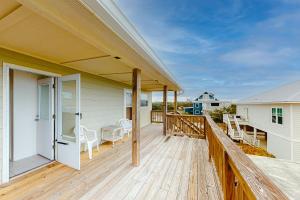 a porch with a wooden deck with a view of the ocean at Campbellot by Meyer Vacation Rentals in Fort Morgan