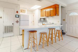 a kitchen with a counter and stools in it at Campbellot by Meyer Vacation Rentals in Fort Morgan
