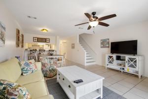 a living room with a couch and a flat screen tv at Blue Shores in Panama City Beach +31 photos