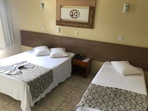Un pat sau paturi într-o cameră la Hotel Boa Vista