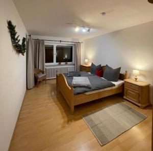 Schlafzimmer mit einem Bett und einem Fenster in der Unterkunft fowo-mangfalltal in Bruckmühl